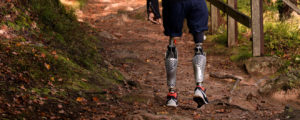 Picture of christoffer walking in the woods with his prosthetics