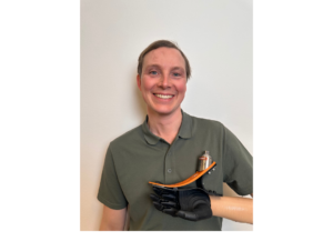 Christoffer Lindhe holding up a prosthetic foot